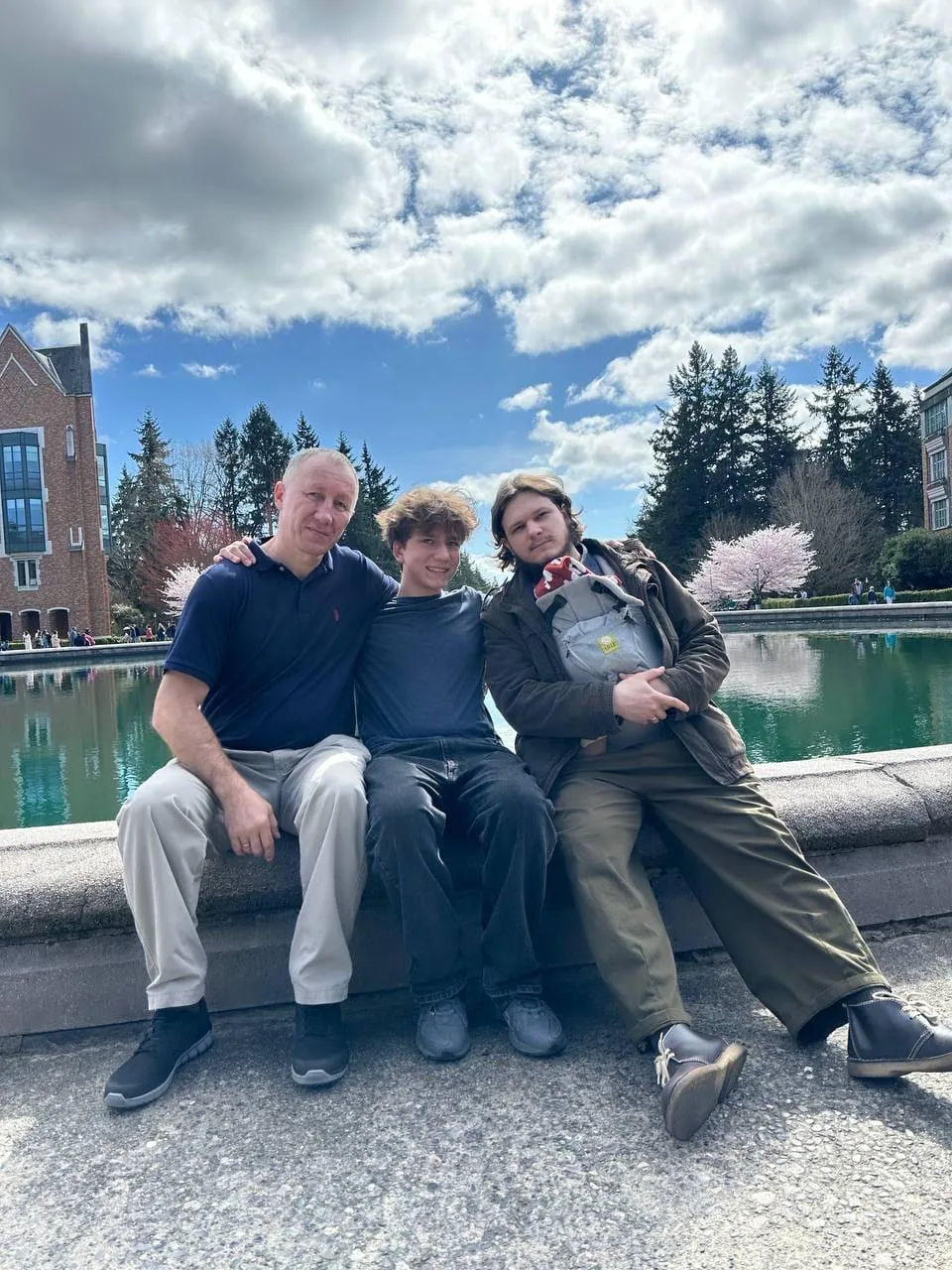 Dmitriy with his sons, the youngest grandchild in a carrier
