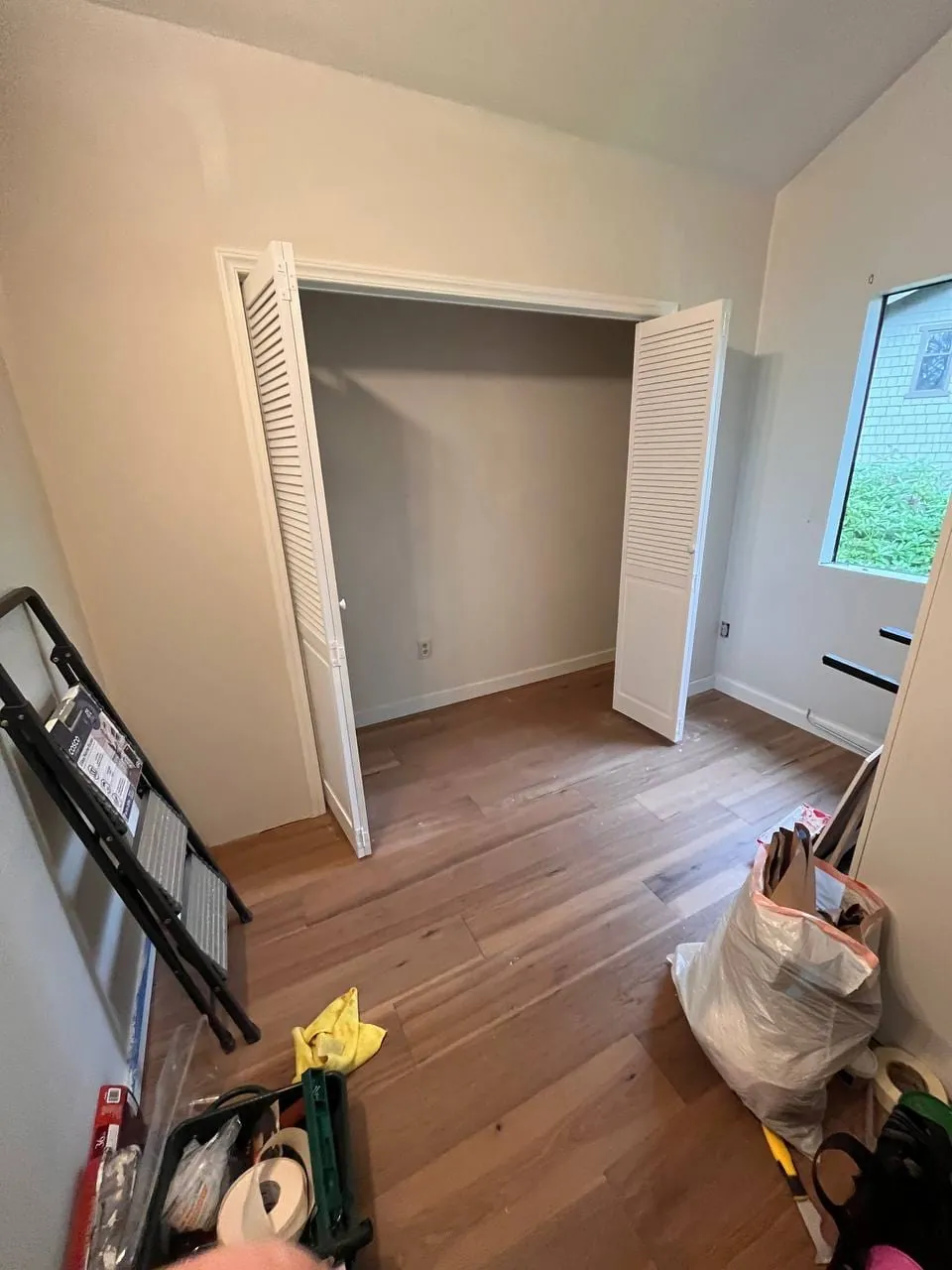 Louvered bi-fold doors hung on the new closet, standing open