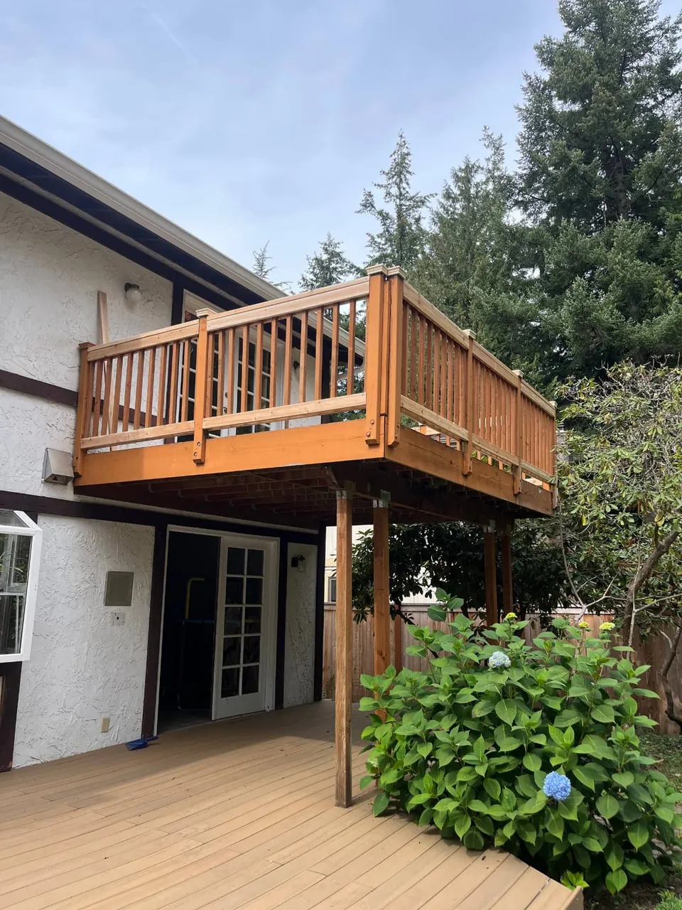 The upper deck and its new railing seen from the patio below