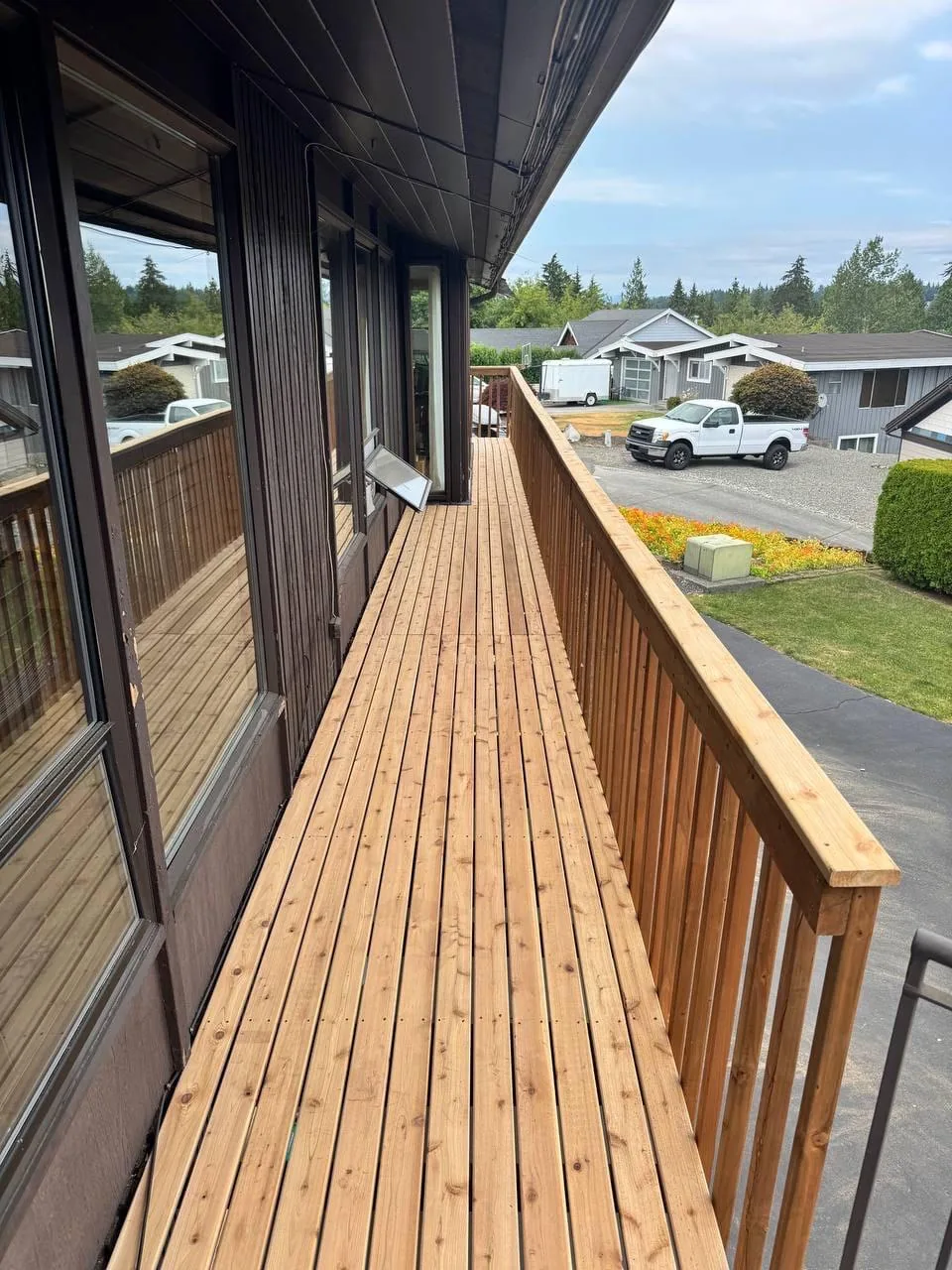 The finished cedar balcony deck and railing, looking along the boards