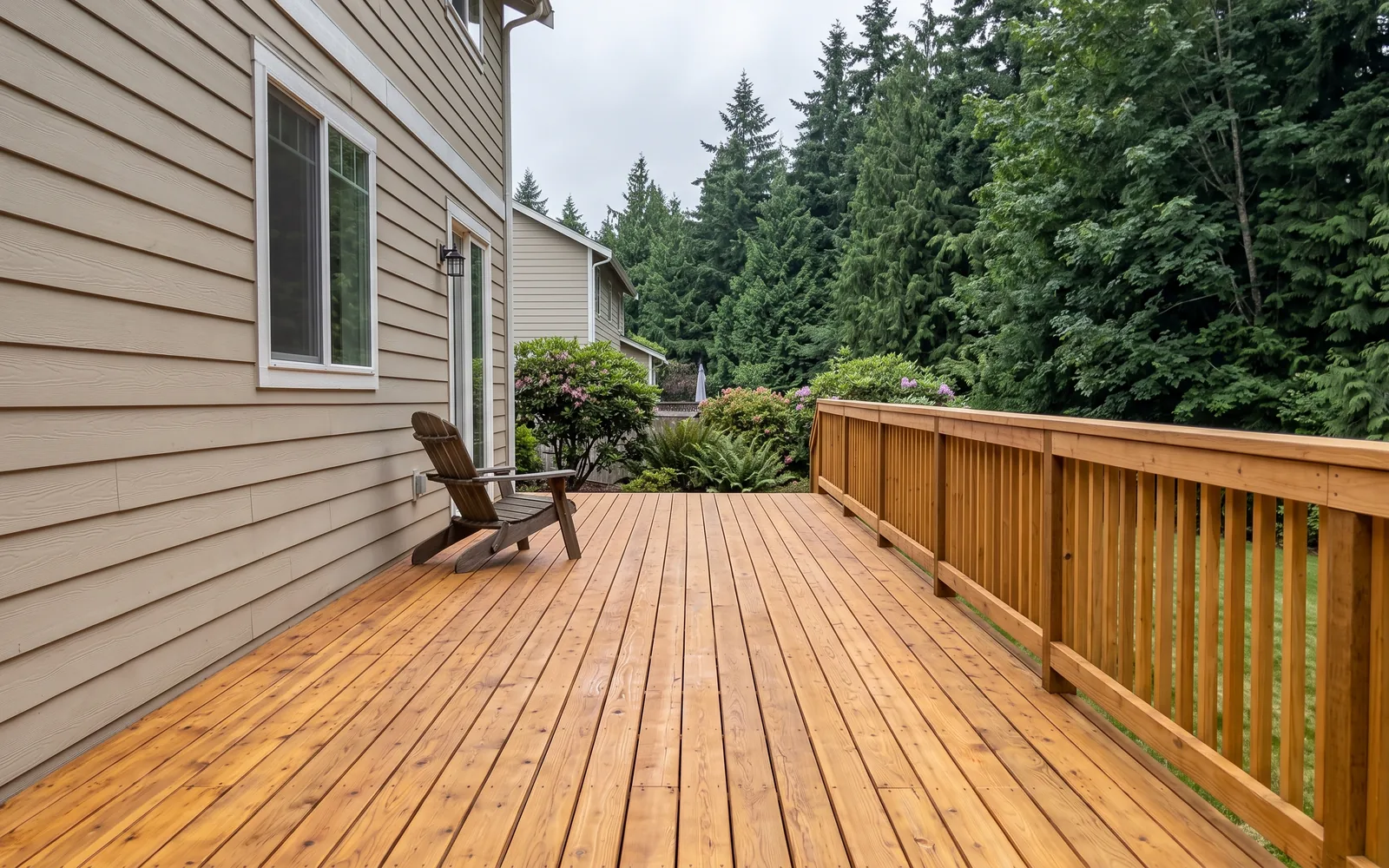 A freshly stained cedar deck, boards running into the frame