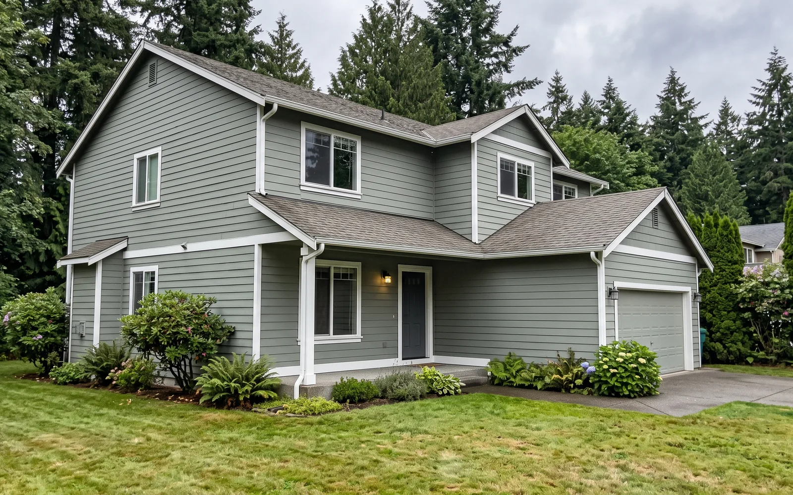 A two-storey house with freshly painted lap siding and white trim