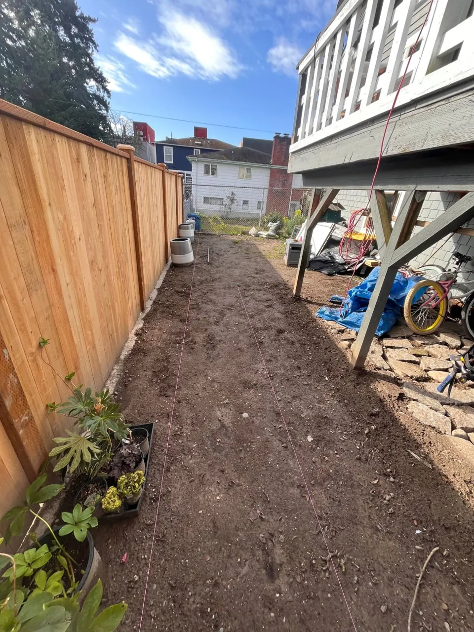 The same fence from the other end, running past the house