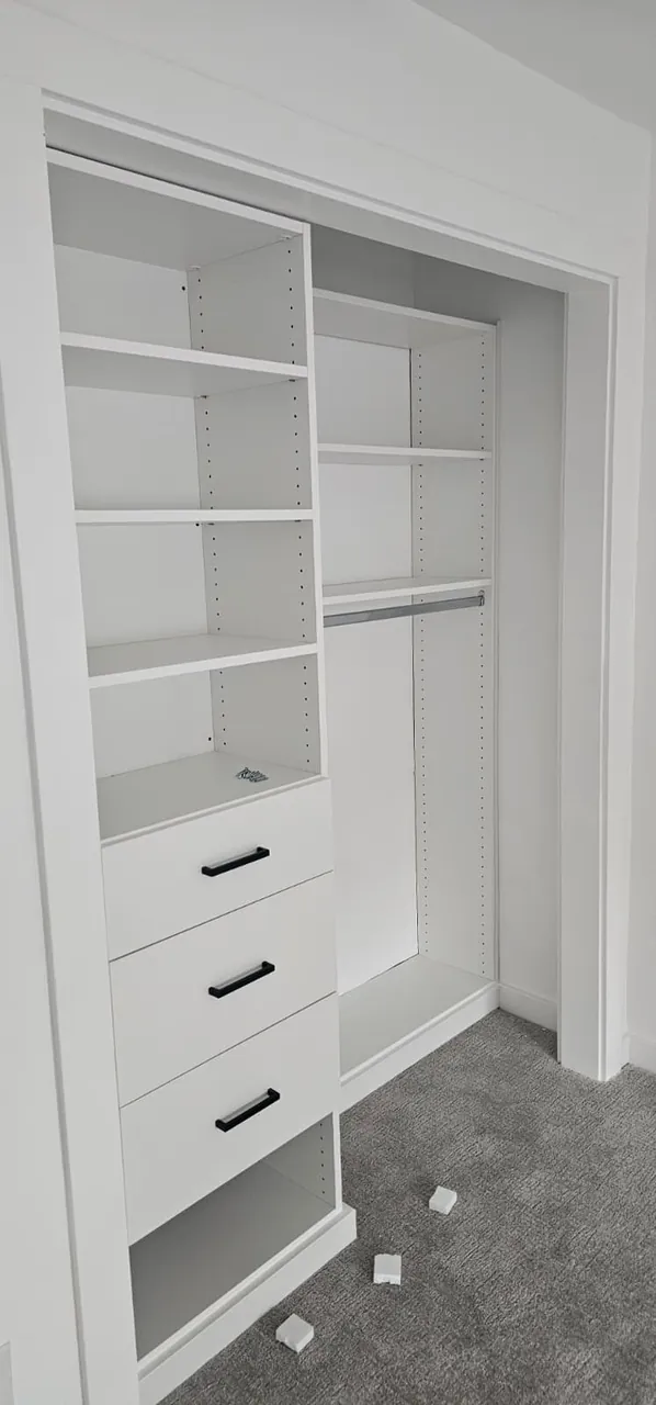 Closet shelves and a hanging rail fitted in an empty closet