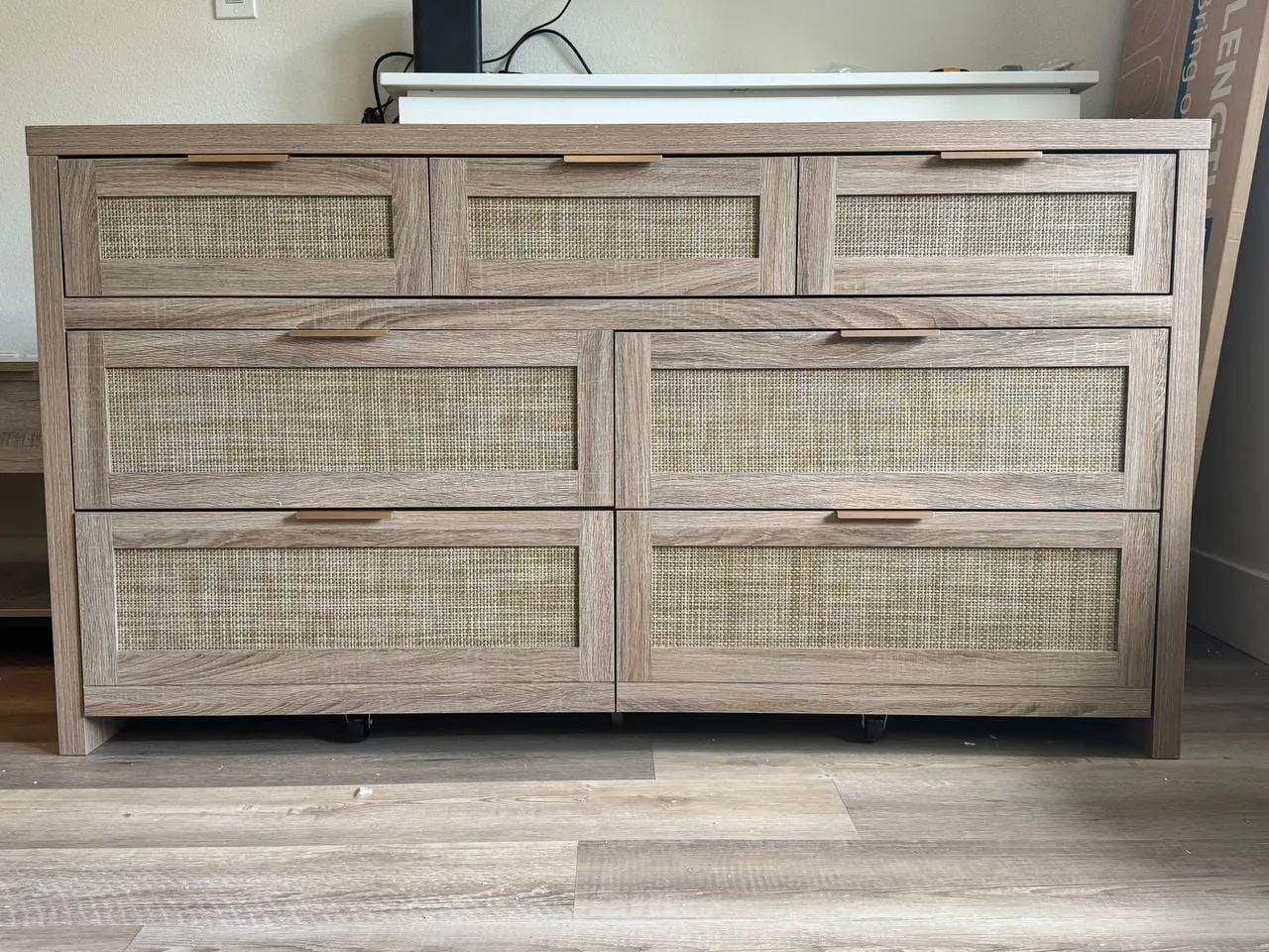 An assembled wide dresser with woven drawer fronts