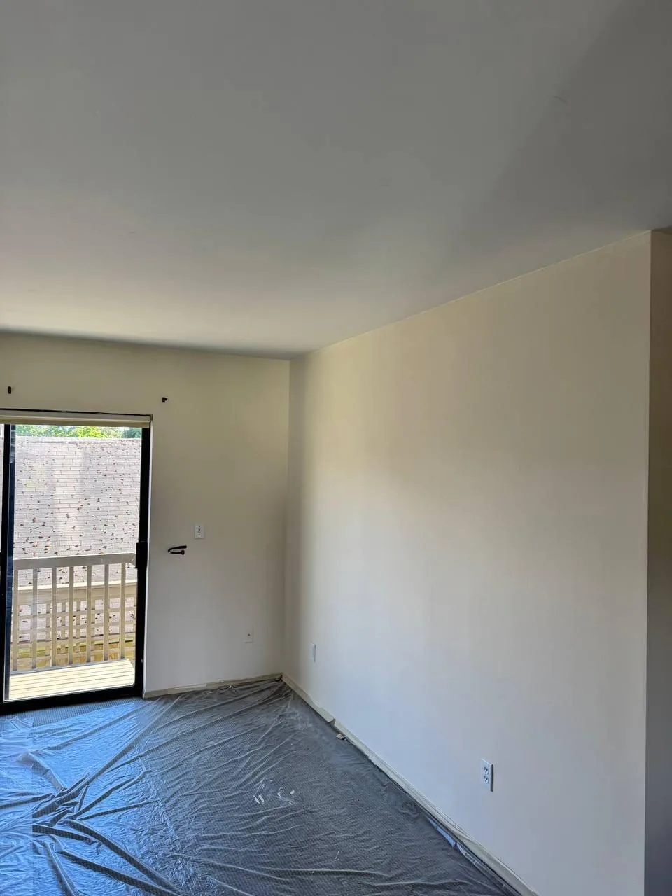 Repainted room with the floor covered in protective sheeting