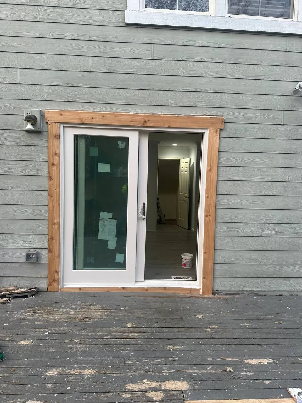 The new patio door from the deck, framed in fresh cedar trim
